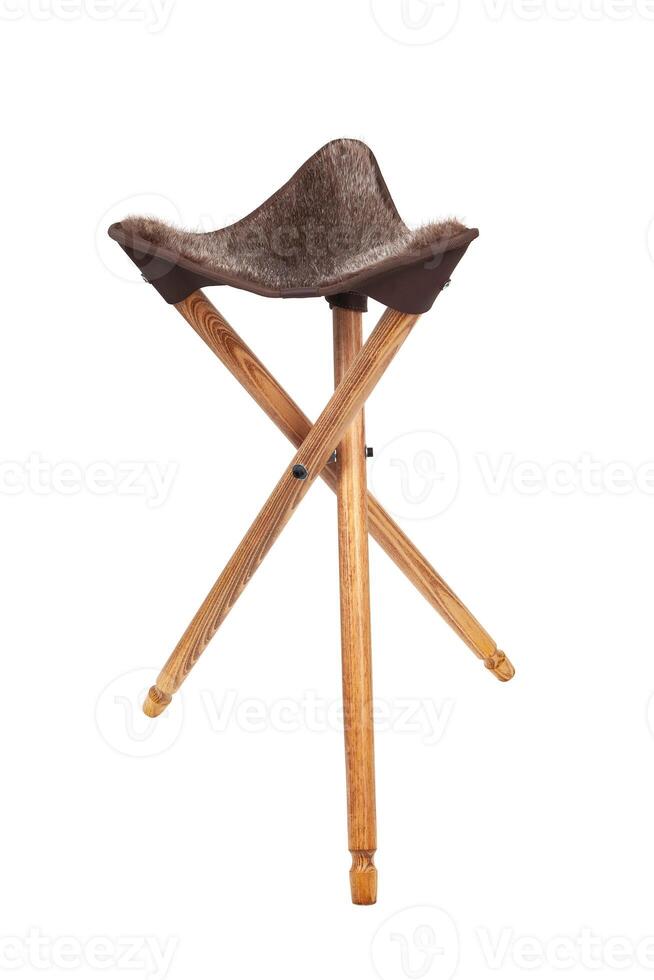 Folding wooden hunting stool tripod isolate on white background. Three-legged camping chair. photo