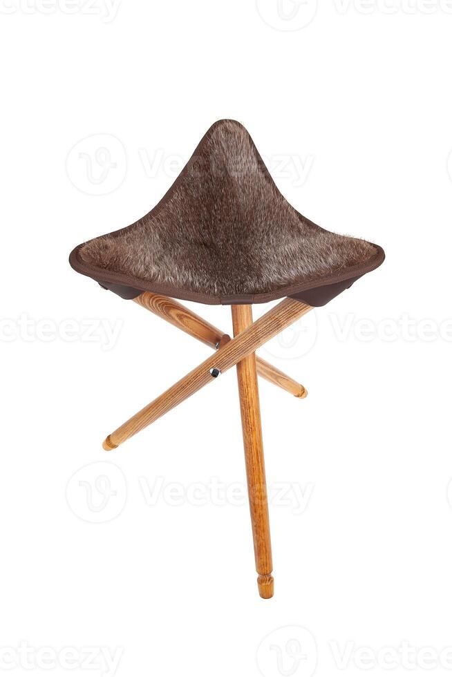 Folding wooden hunting stool tripod isolate on white background. Three-legged camping chair. photo