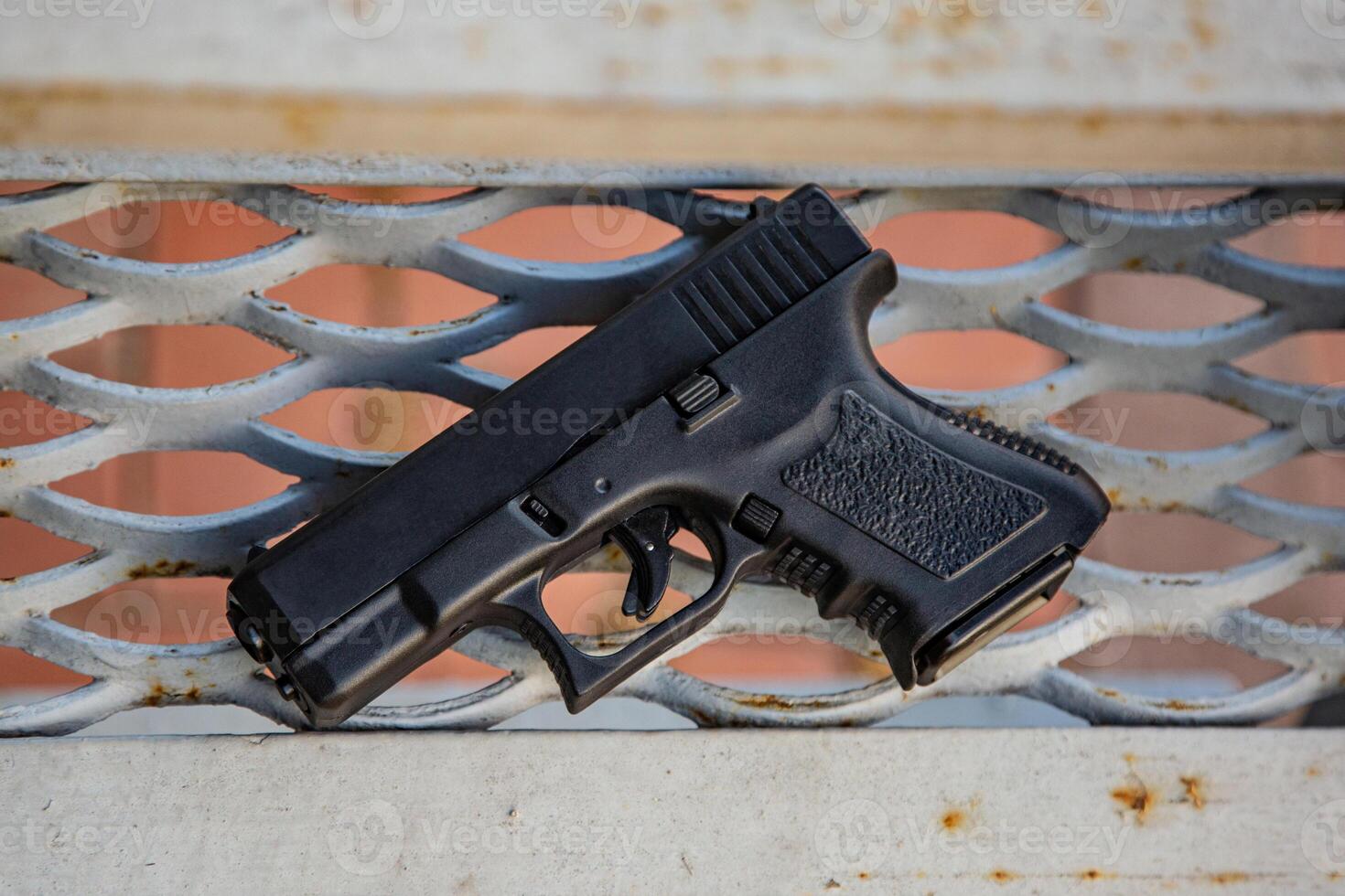Modern semi-automatic pistol. Armament for the army and police. Short-barreled weapon. Metal lattice back photo