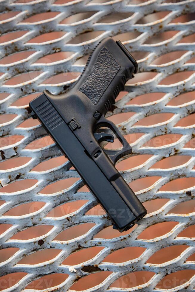 Modern semi-automatic pistol. Armament for the army and police. Short-barreled weapon. Metal lattice back photo