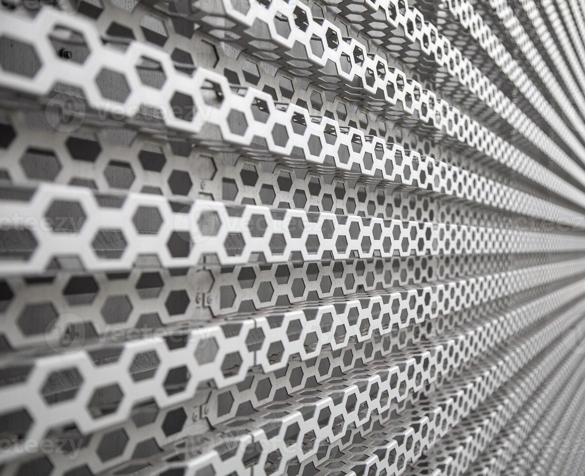 Background of wavy metallic grid with holes. Metal mesh as background. Perforated metal back. photo