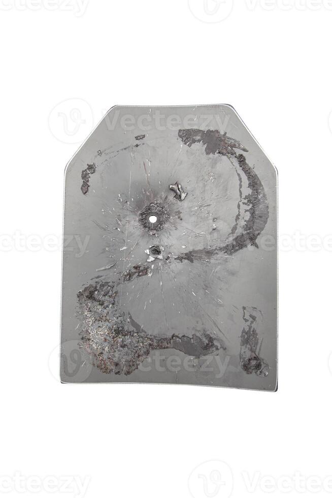 The metal plate of the bulletproof vest pierced by a bullet. Isolate on a white back. photo