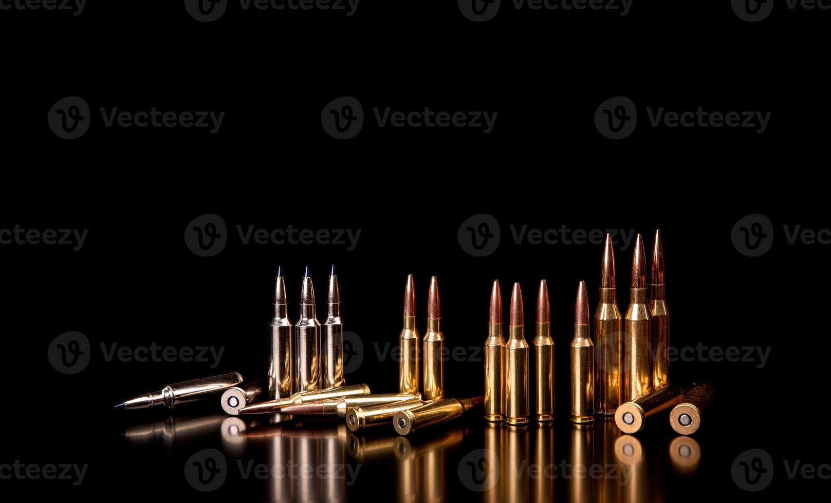 Bullet isolated on black background with reflexion. Rifle bullets close-up on black back. Cartridges for rifle and carbine on a black. photo