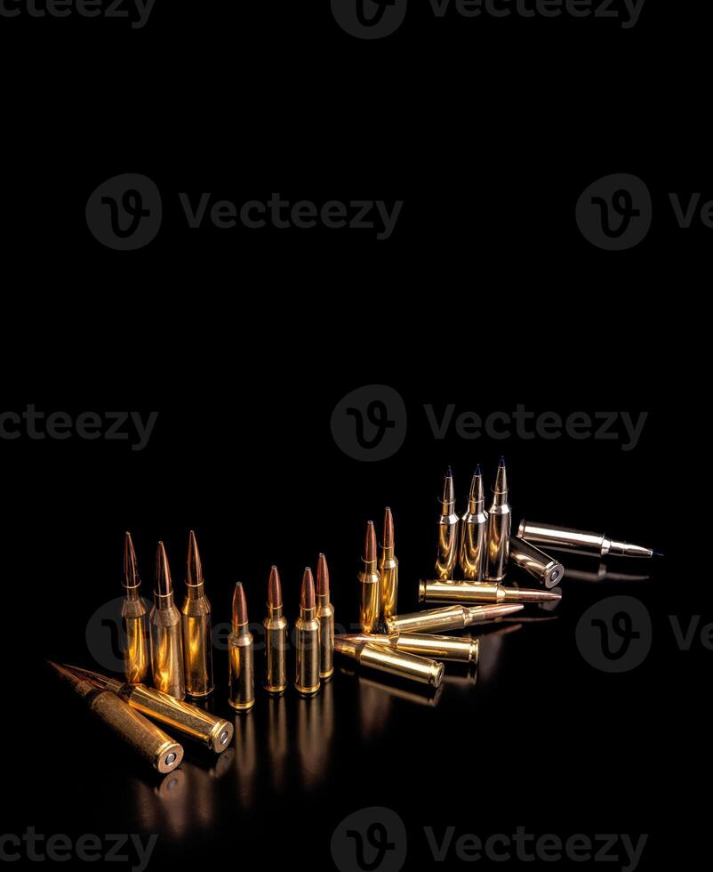 Bullet isolated on black background with reflexion. Rifle bullets close-up on black back. Cartridges for rifle and carbine on a black. photo