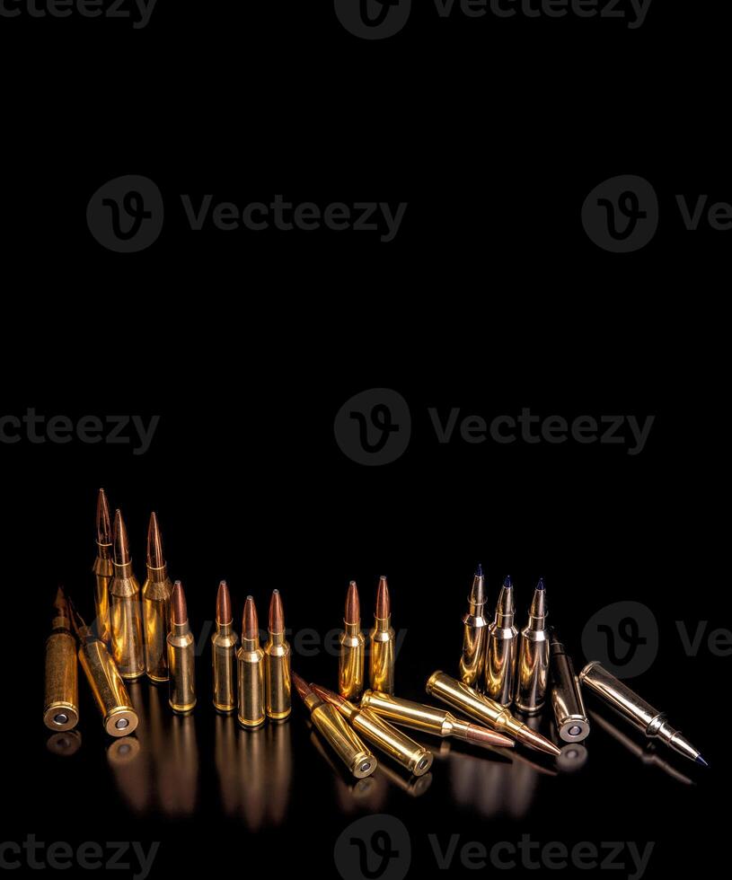 Bullet isolated on black background with reflexion. Rifle bullets close-up on black back. Cartridges for rifle and carbine on a black photo