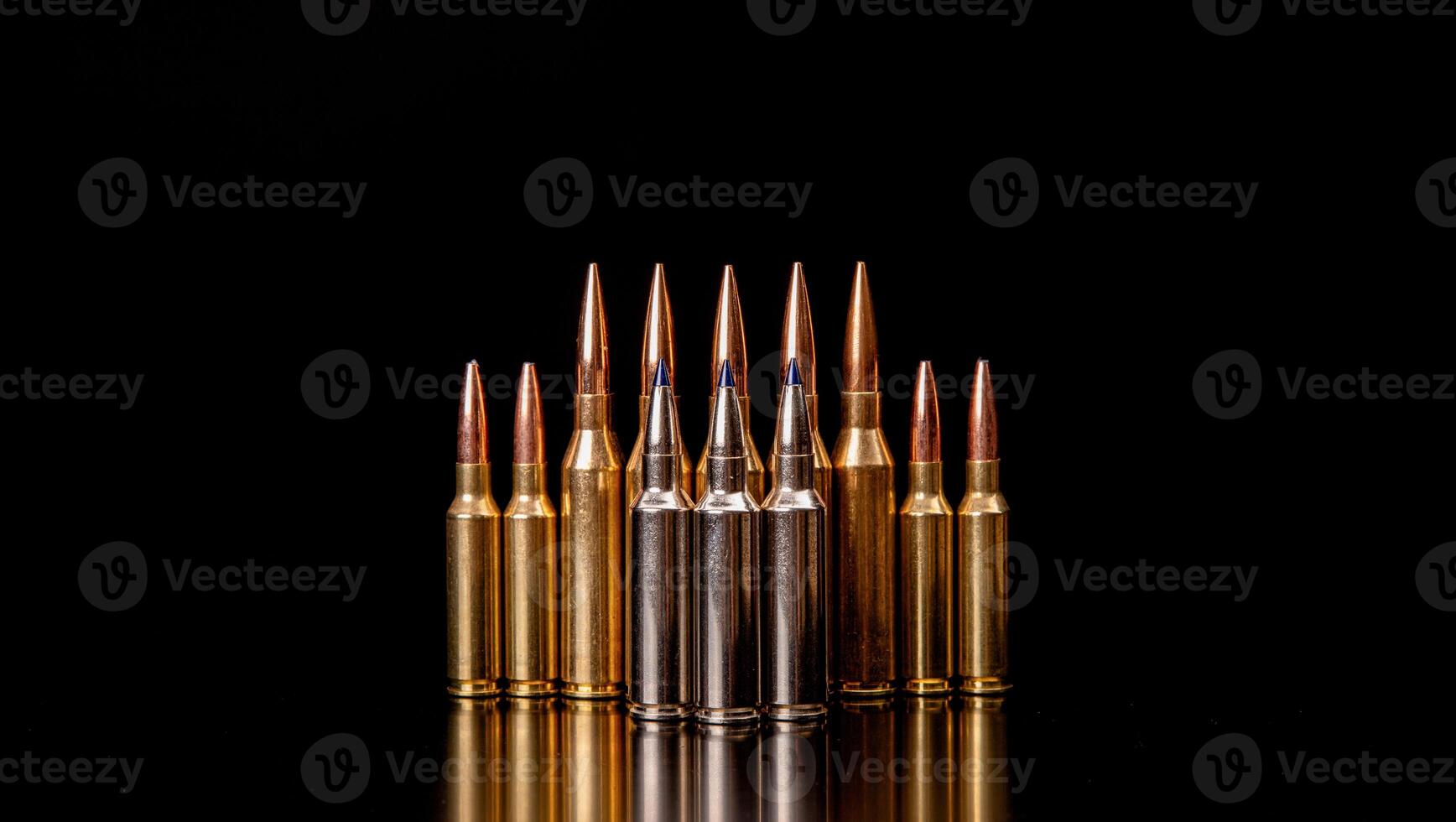 Bullet isolated on black background with reflexion. Rifle bullets close-up on black back. Cartridges for rifle and carbine on a black. photo