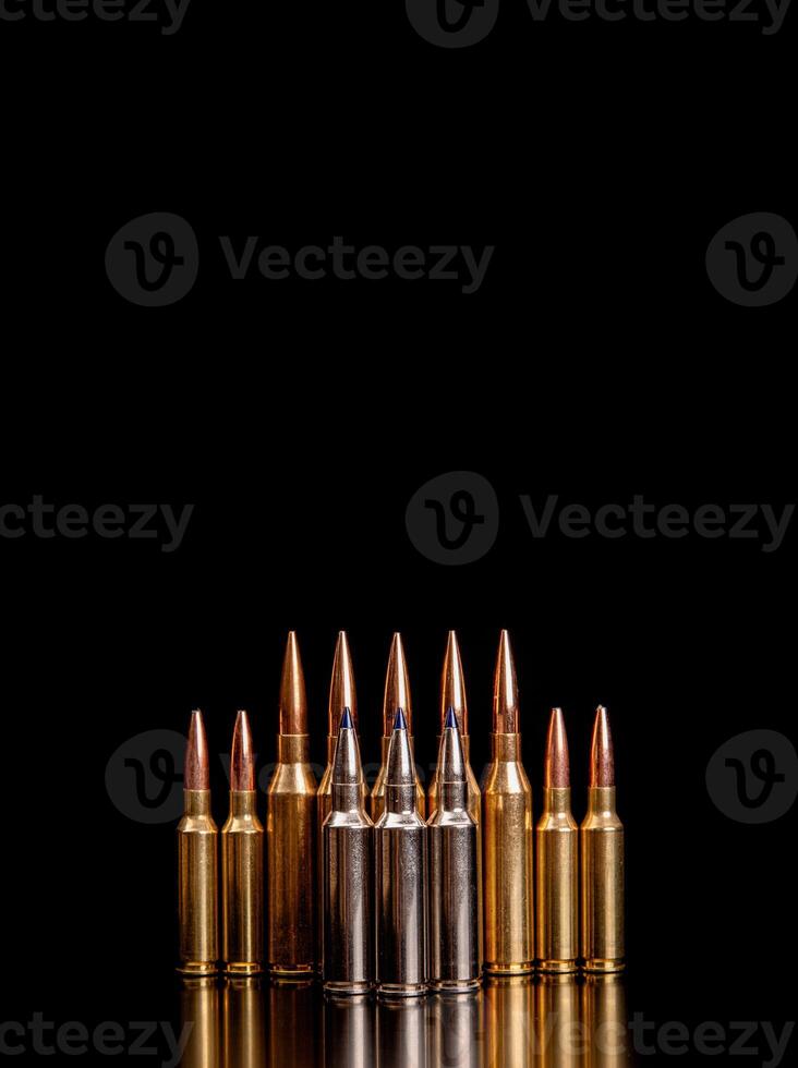Bullet isolated on black background with reflexion. Rifle bullets close-up on black back. Cartridges for rifle and carbine on a black. photo