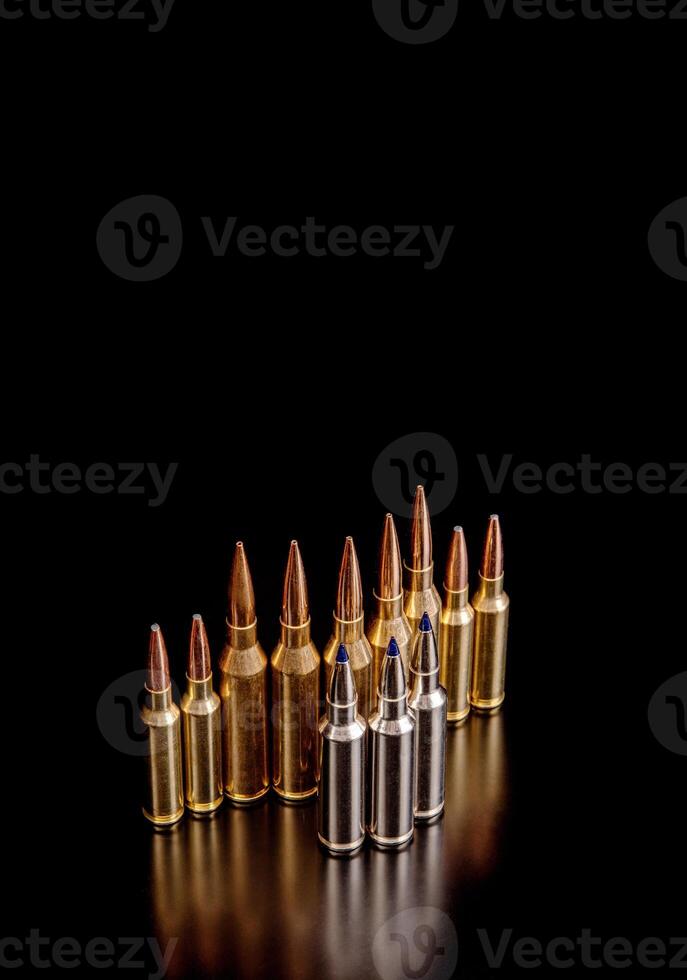 Bullet isolated on black background with reflexion. Rifle bullets close-up on black back. Cartridges for rifle and carbine on a black. photo