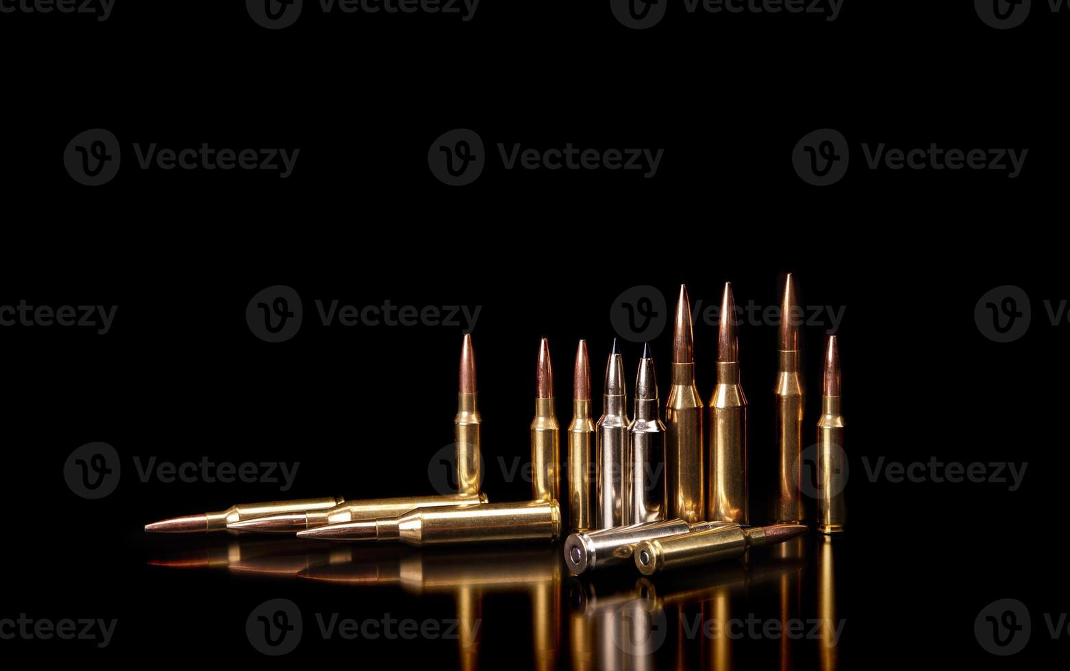 Bullet isolated on black background with reflexion. Rifle bullets close-up on black back. Cartridges for rifle and carbine on a black. photo