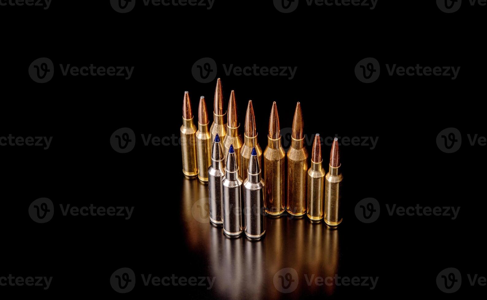 Bullet isolated on black background with reflexion. Rifle bullets close-up on black back. Cartridges for rifle and carbine on a black. photo