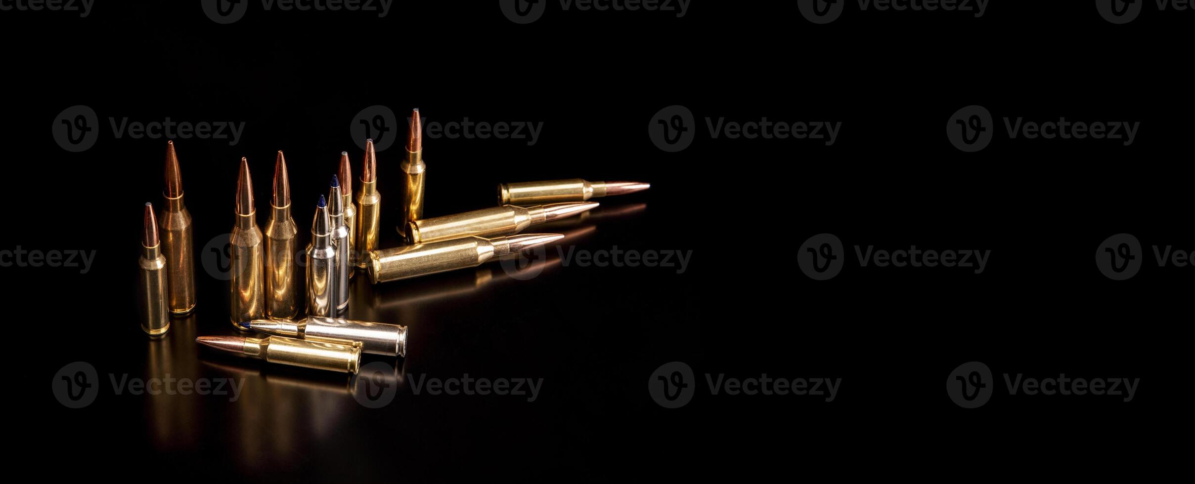 Bullet isolated on black background with reflexion. Rifle bullets close-up on black back. Cartridges for rifle and carbine on a black. photo