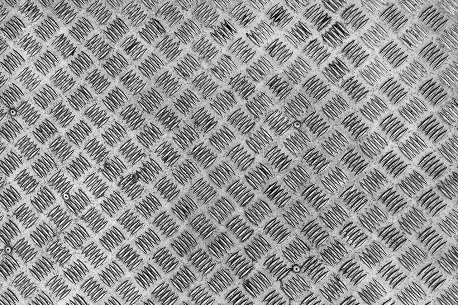 Metal surface with diamond plate texture. The diamond steel metal sheet. Pattern of old metal diamond plate. Industrial light back. photo