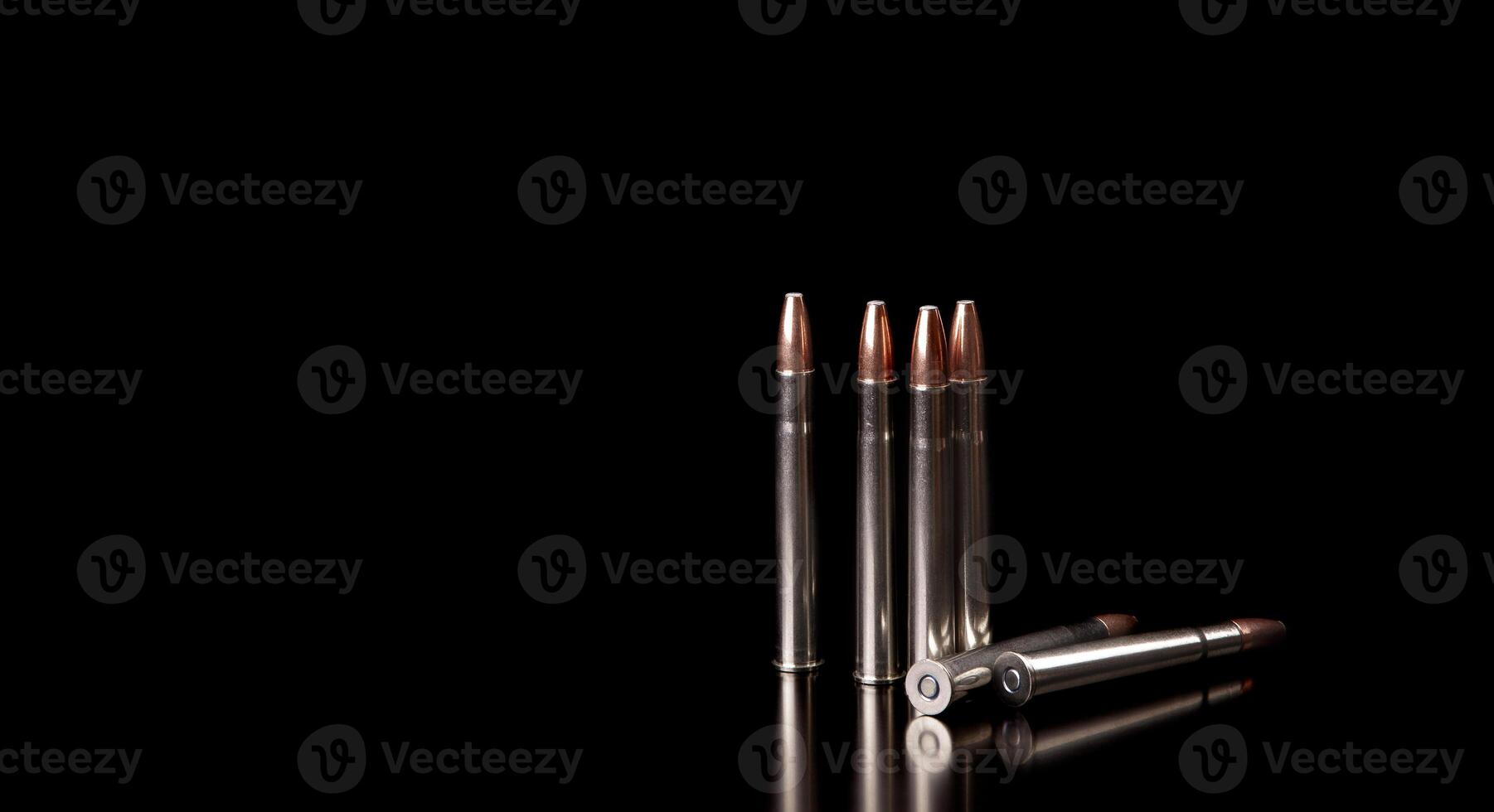 Bullet isolated on black background with reflexion. Rifle bullets close-up on black back. Cartridges for rifle and carbine on a black. photo