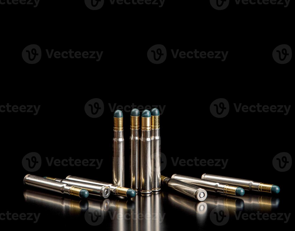 Bullet isolated on black background with reflexion. Rifle bullets close-up on black back. Cartridges for rifle and carbine on a black. photo