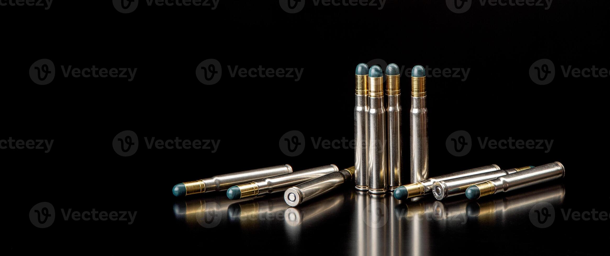 Bullet isolated on black background with reflexion. Rifle bullets close-up on black back. Cartridges for rifle and carbine on a black. photo
