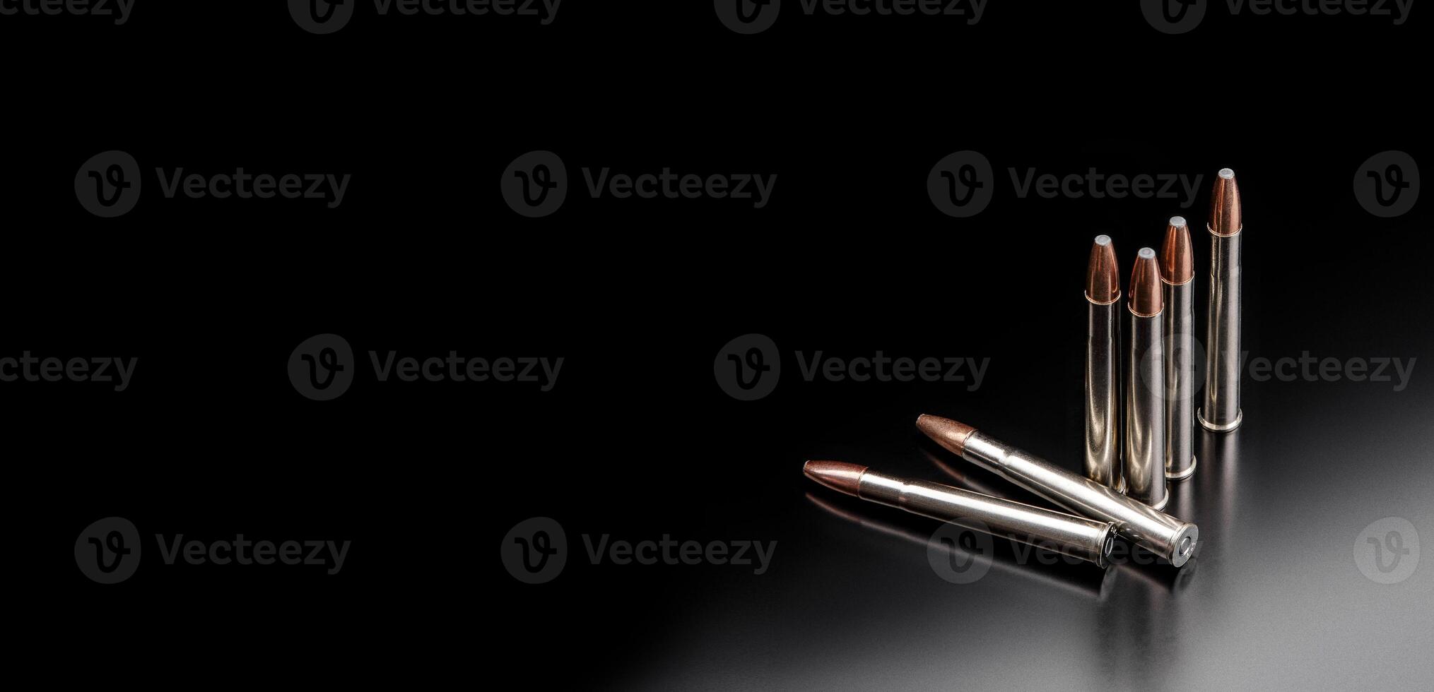 Bullet isolated on black background with reflexion. Rifle bullets close-up on black back. Cartridges for rifle and carbine on a black. photo
