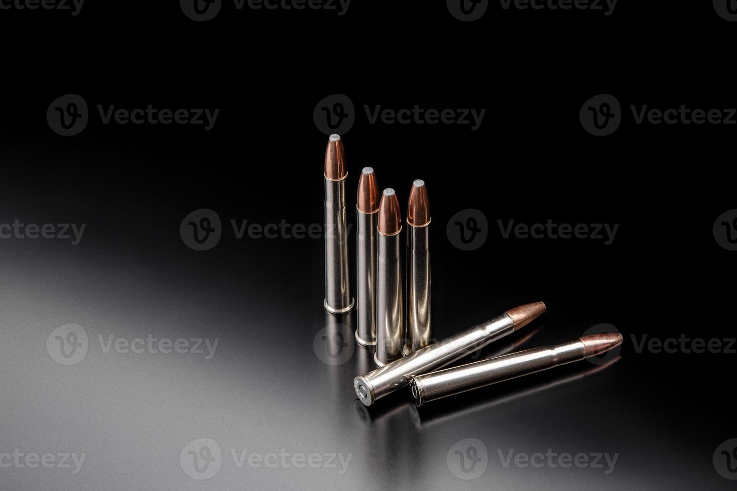 Bullet isolated on black background with reflexion. Rifle bullets close-up on black back. Cartridges for rifle and carbine on a black. photo