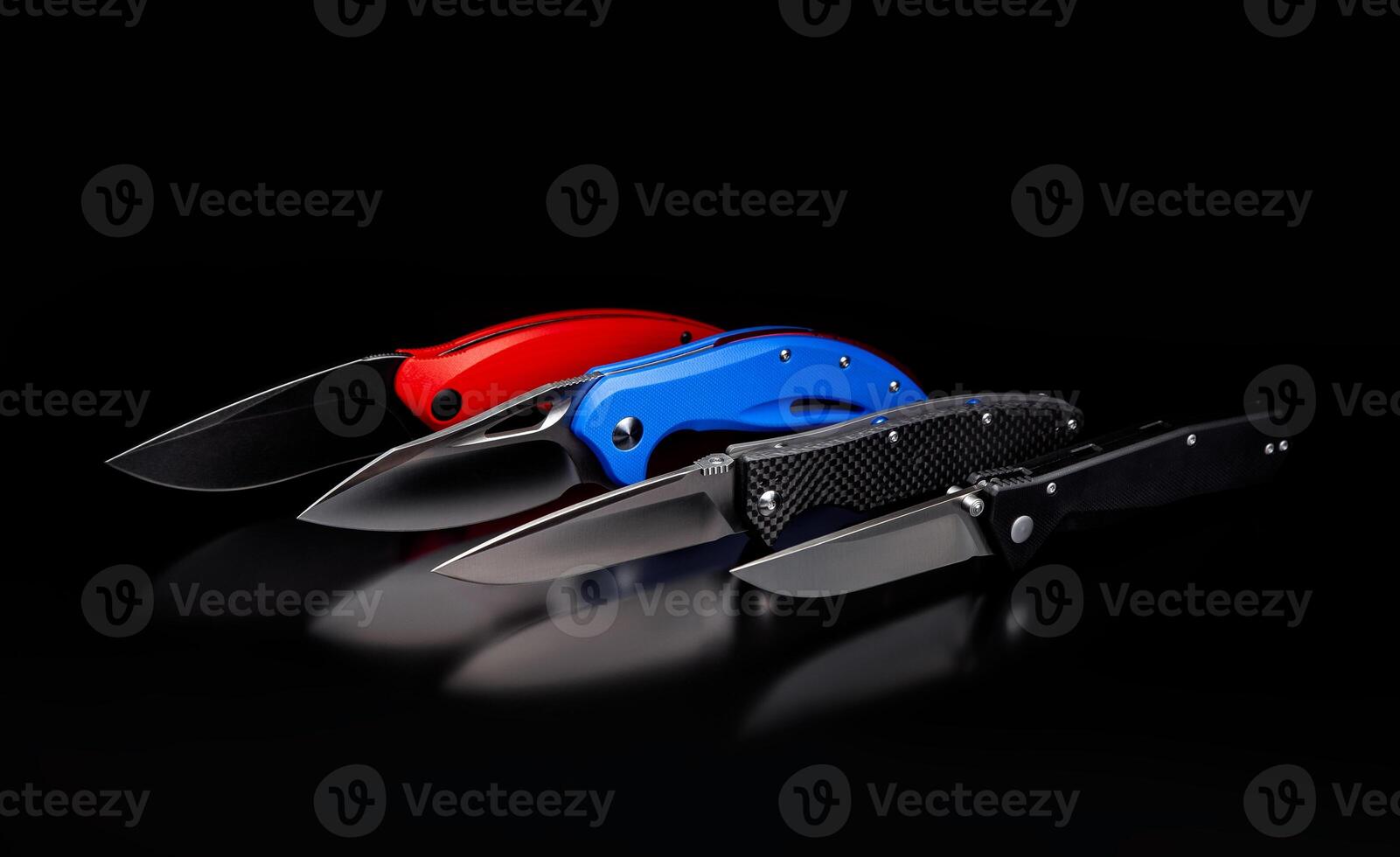 folding knives on a black background. pen knives on a dark background photo