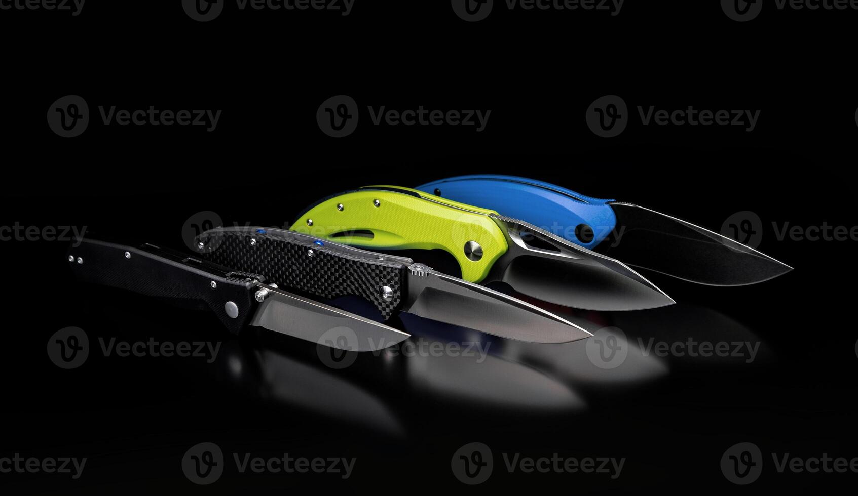 folding knives on a black background. pen knives on a dark background photo