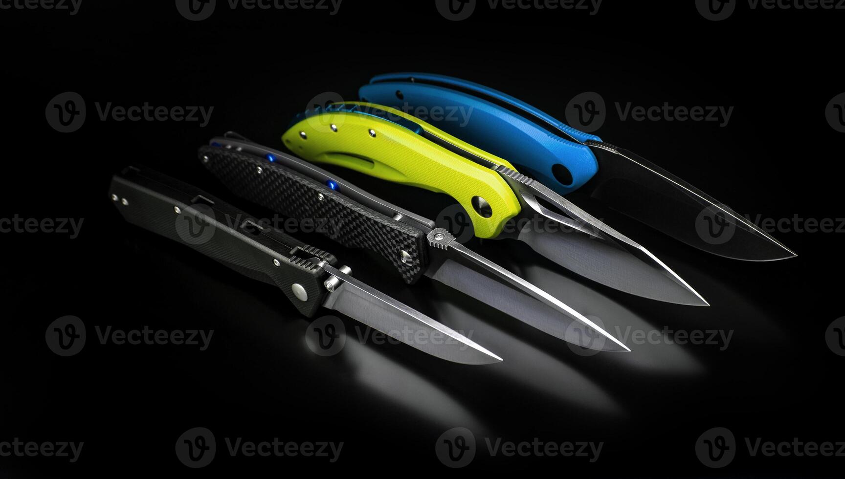 folding knives on a black background. pen knives on a dark background photo
