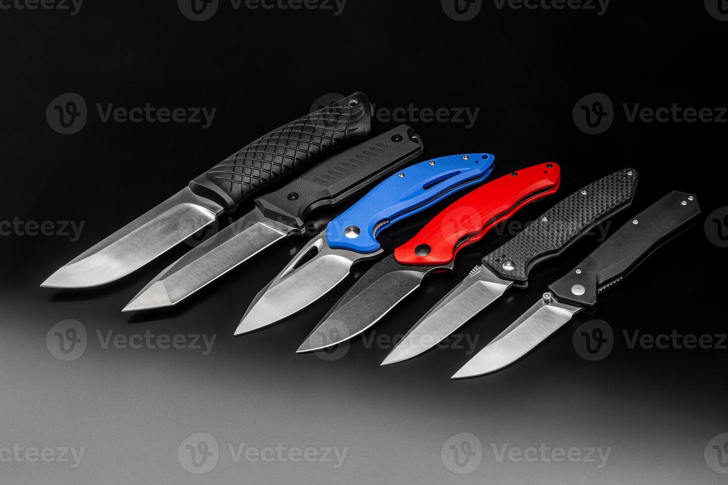 folding knives on a black background. pen knives on a dark background photo