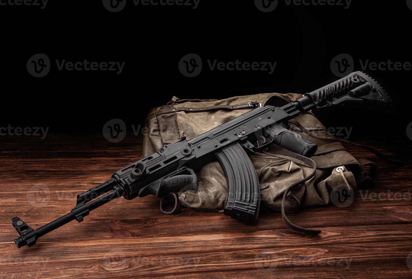Soviet carbine in modern body kit. Weapons of Russia and the Soviet Union. Classic Soviet AK machine gun on a wooden back photo