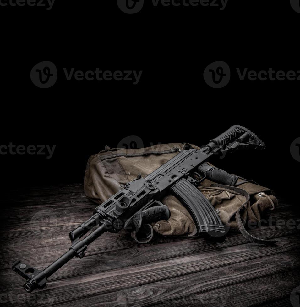 Soviet carbine in modern body kit. Weapons of Russia and the Soviet Union. Classic Soviet AK machine gun on a wooden back photo