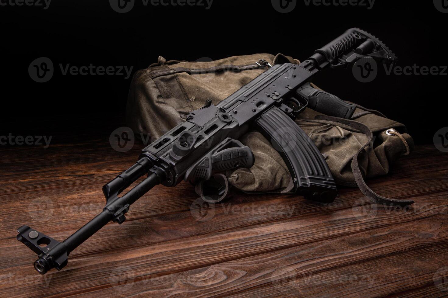 Soviet carbine in modern body kit. Weapons of Russia and the Soviet Union. Classic Soviet AK machine gun on a wooden back photo
