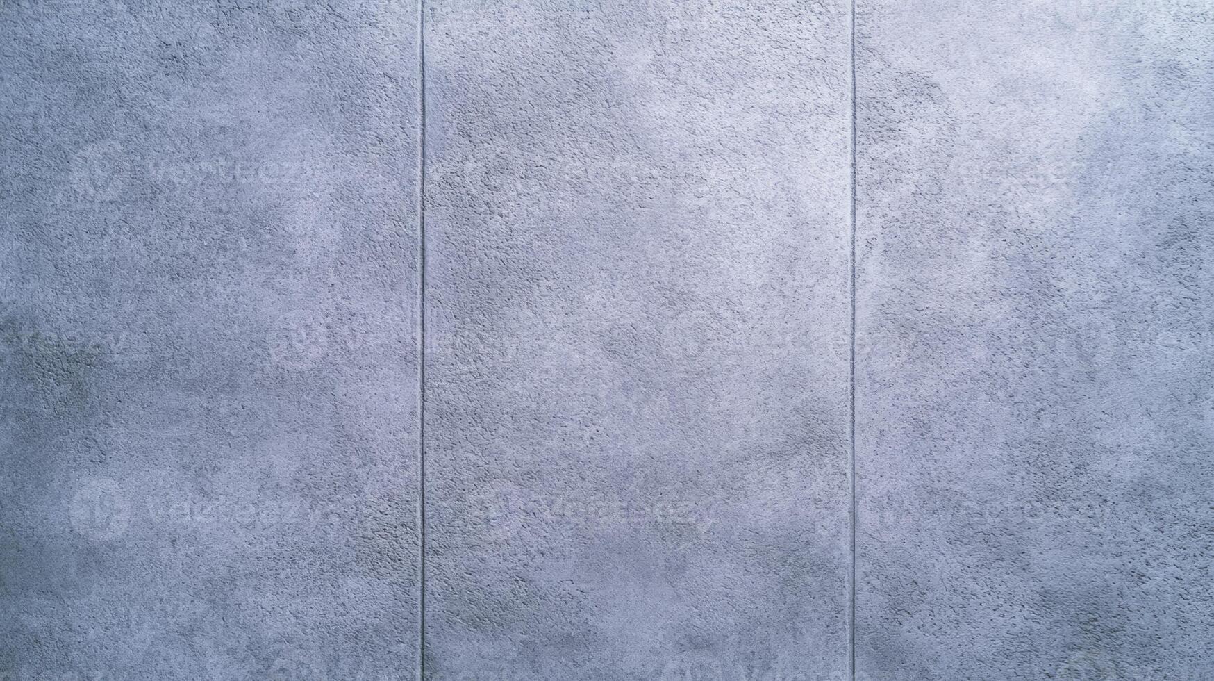 Overhead view of a plain concrete wall surface with soft shadow details and subtle texture light gray with a polished clean finish ideal for neutral backgrounds photo