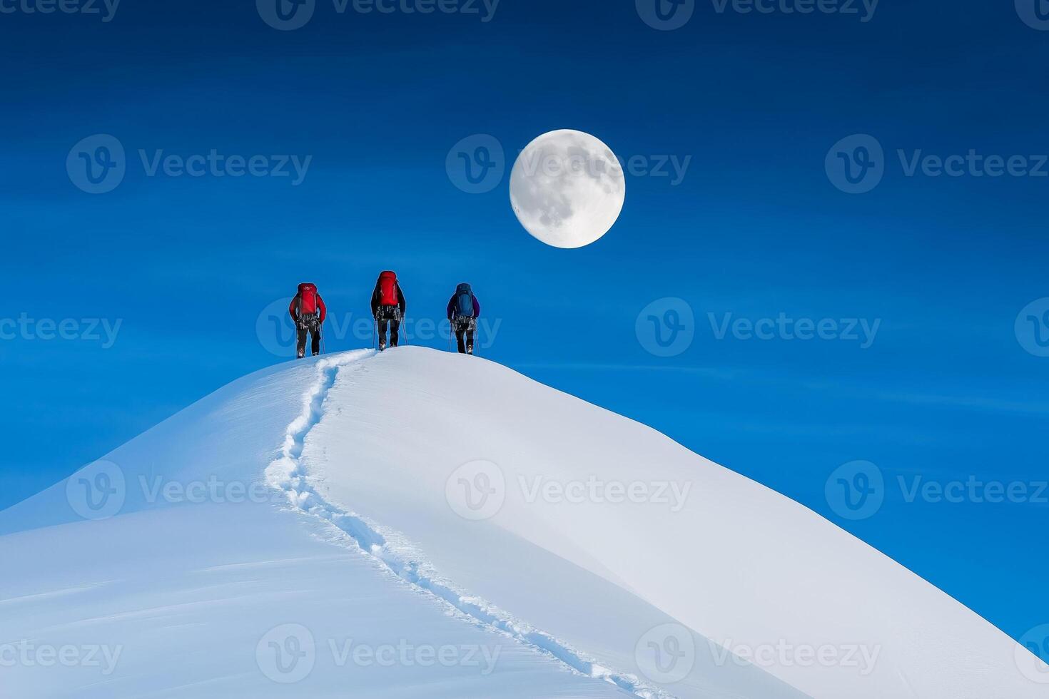Climbers ascend ice covered mountain peak under a full moon photo