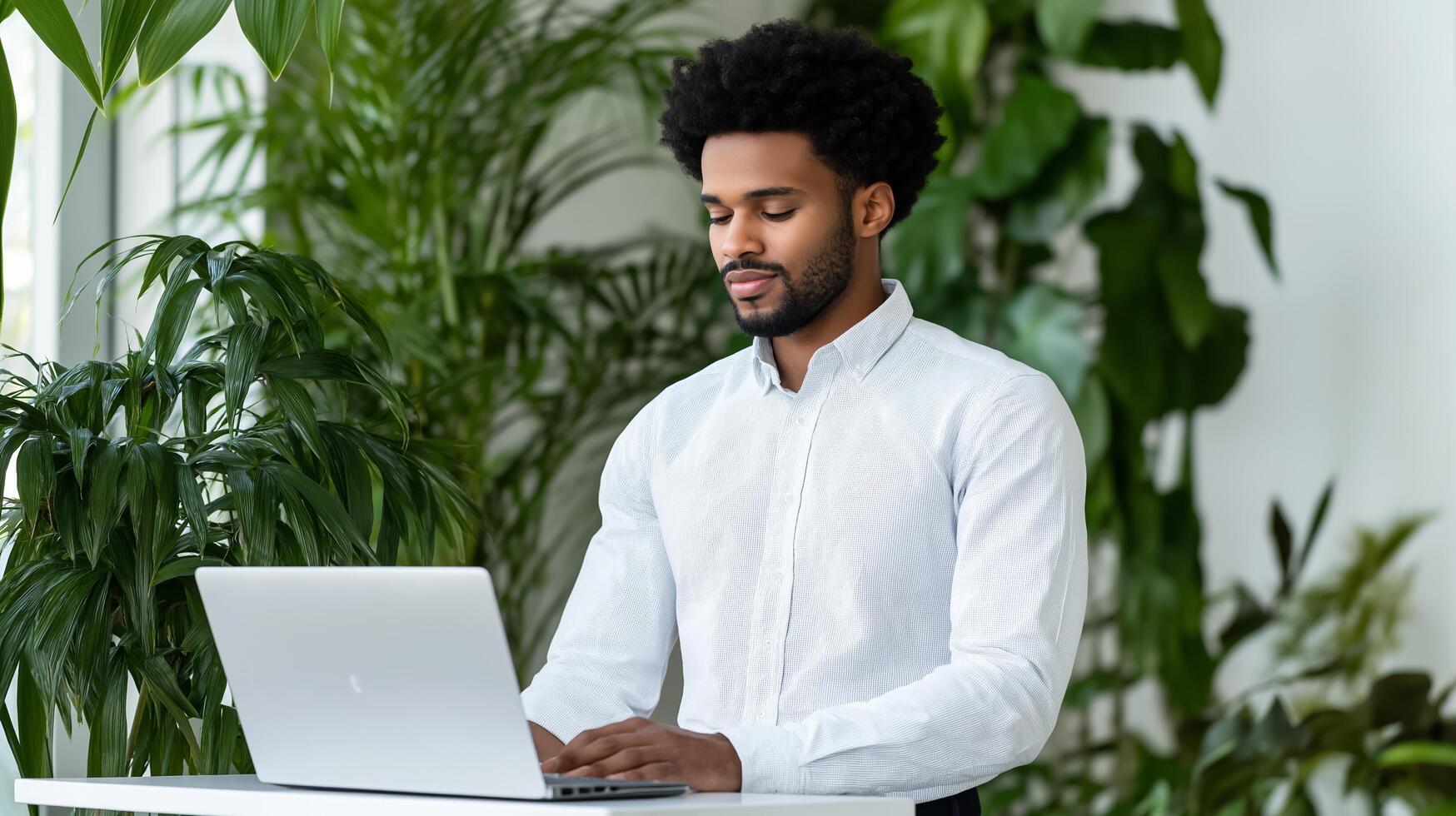 Joyful employee using a standing desk in a modern office plants and sunlight abundant wellness focused environment designed for comfort and mental clarity photo