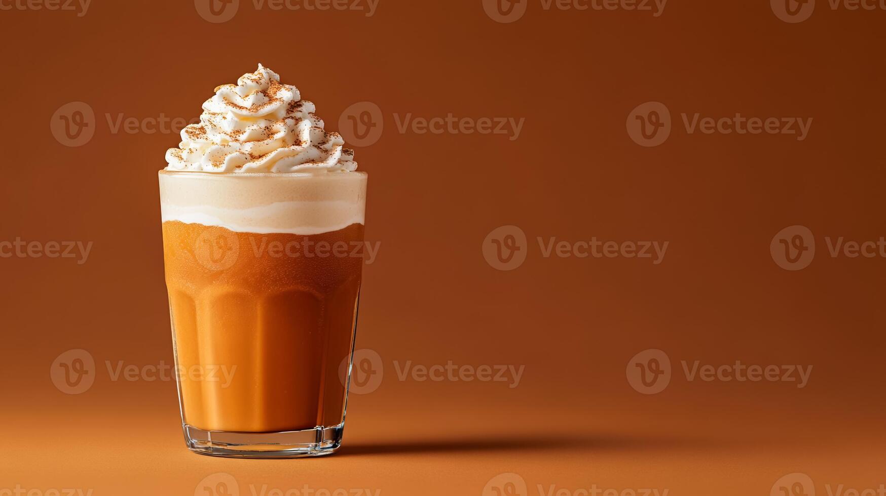 Seasonal pumpkin spice cocktail with rum and cream, garnished with whipped cream and nutmeg, served in a glass tumbler against a gradient background fading from burnt orange to dark brown photo