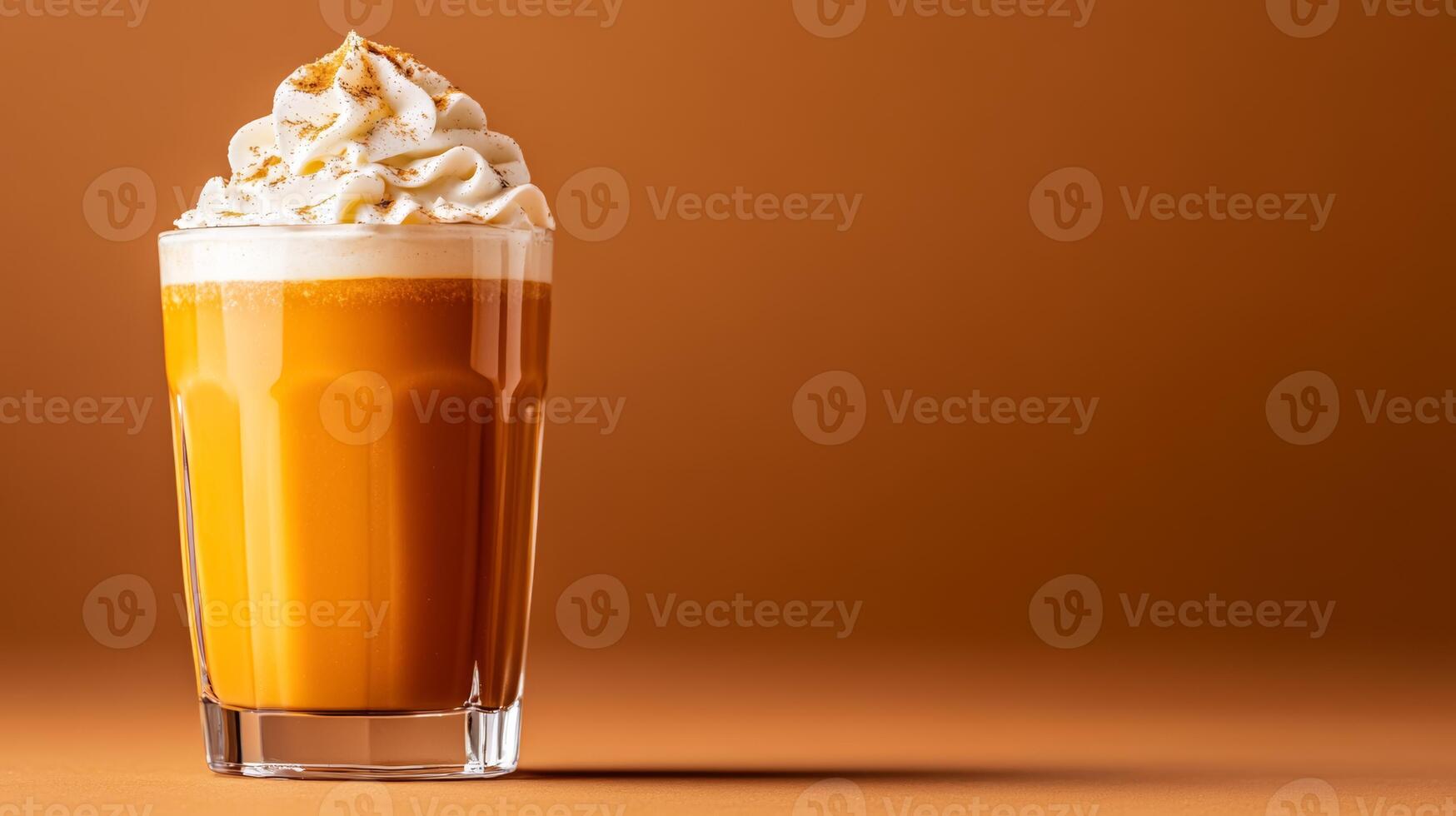 Seasonal pumpkin spice cocktail with rum and cream, garnished with whipped cream and nutmeg, served in a glass tumbler against a gradient background fading from burnt orange to dark brown photo