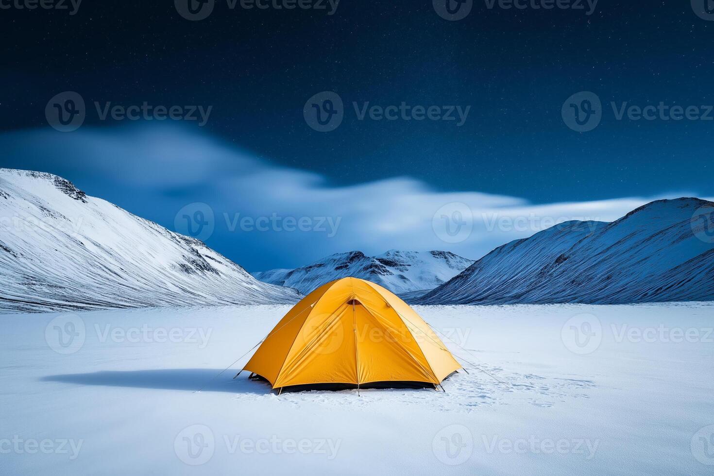 Tent nestled in snowy mountain landscape under a starlit sky photo