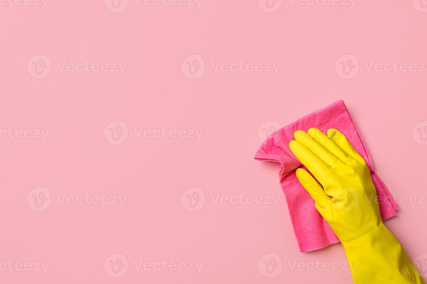 Hand in glove on pink background. Cleaning concept photo