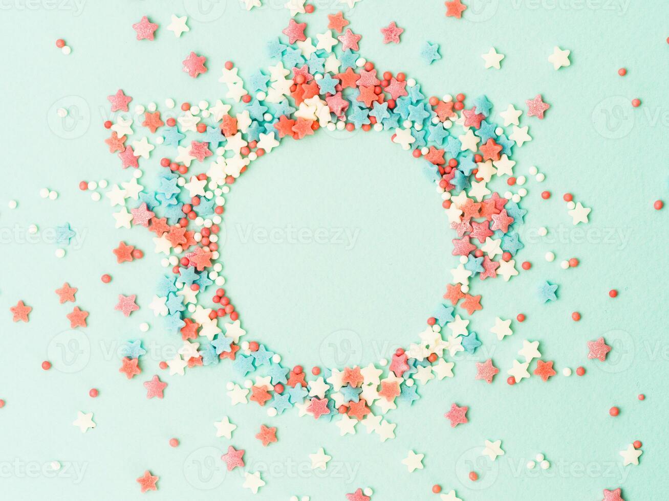 Sprinkles in round spahe on blue, copy space photo