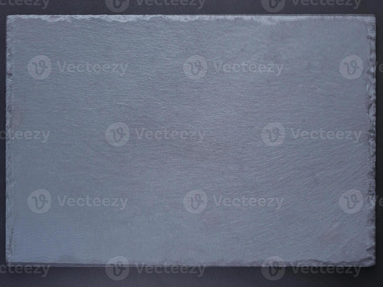 Empty black slate board for serving on dark background. Flat lay or top view. Can use fo design menu photo