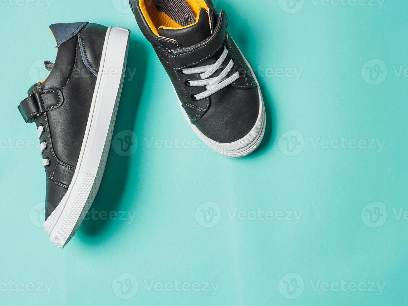 Gray and yellow sneakers on blue background photo