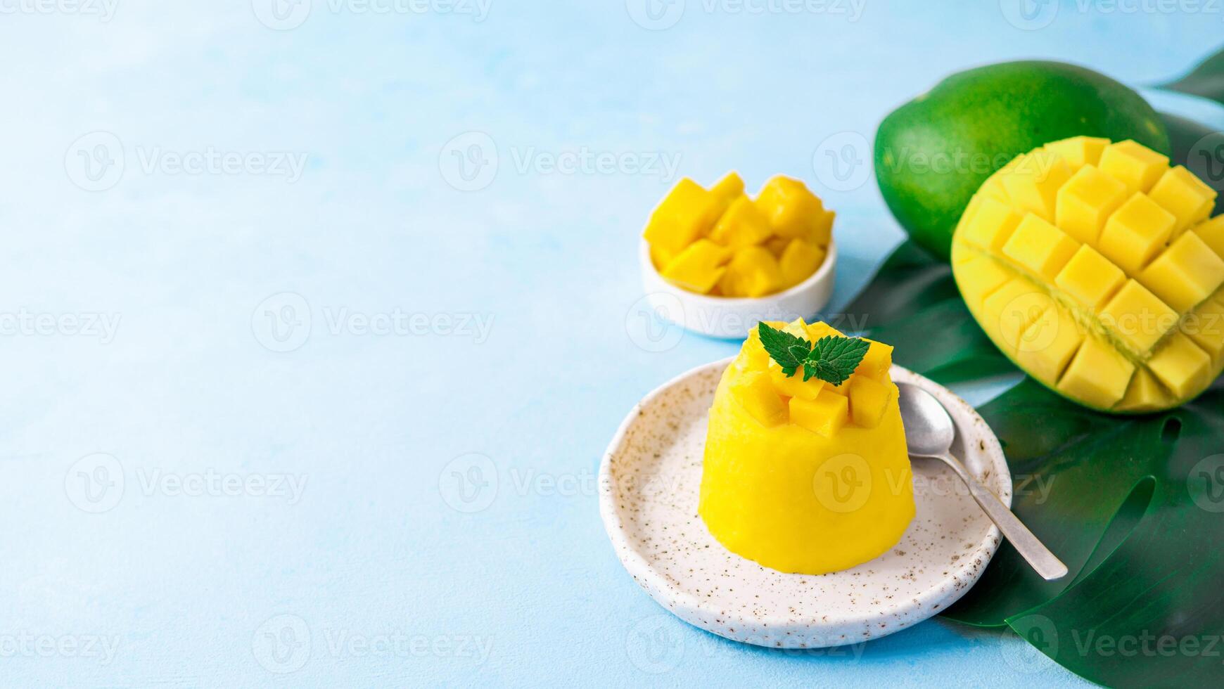 Mango Mousse on blue background, copy space photo