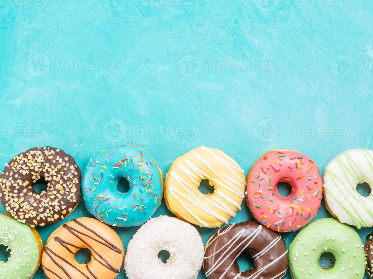 donuts on blue background , copy space, top view photo