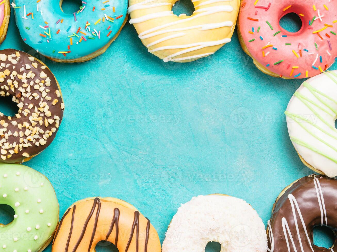 donuts on blue background , copy space, top view photo