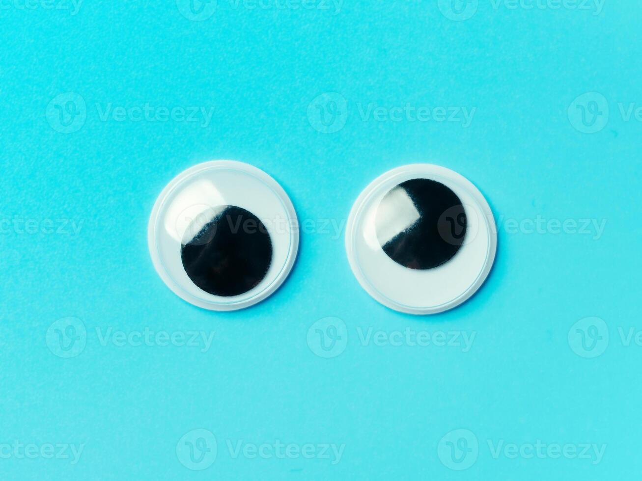 googly eyes on turquoise background photo