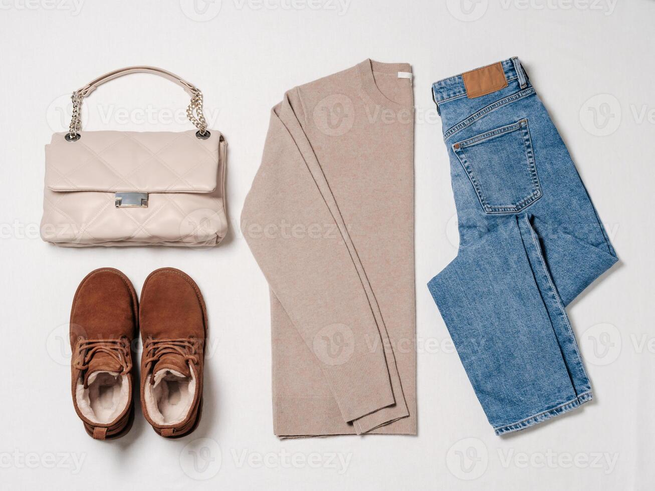 Winter cozy fashion flat lay with sweater, jeans, boots photo