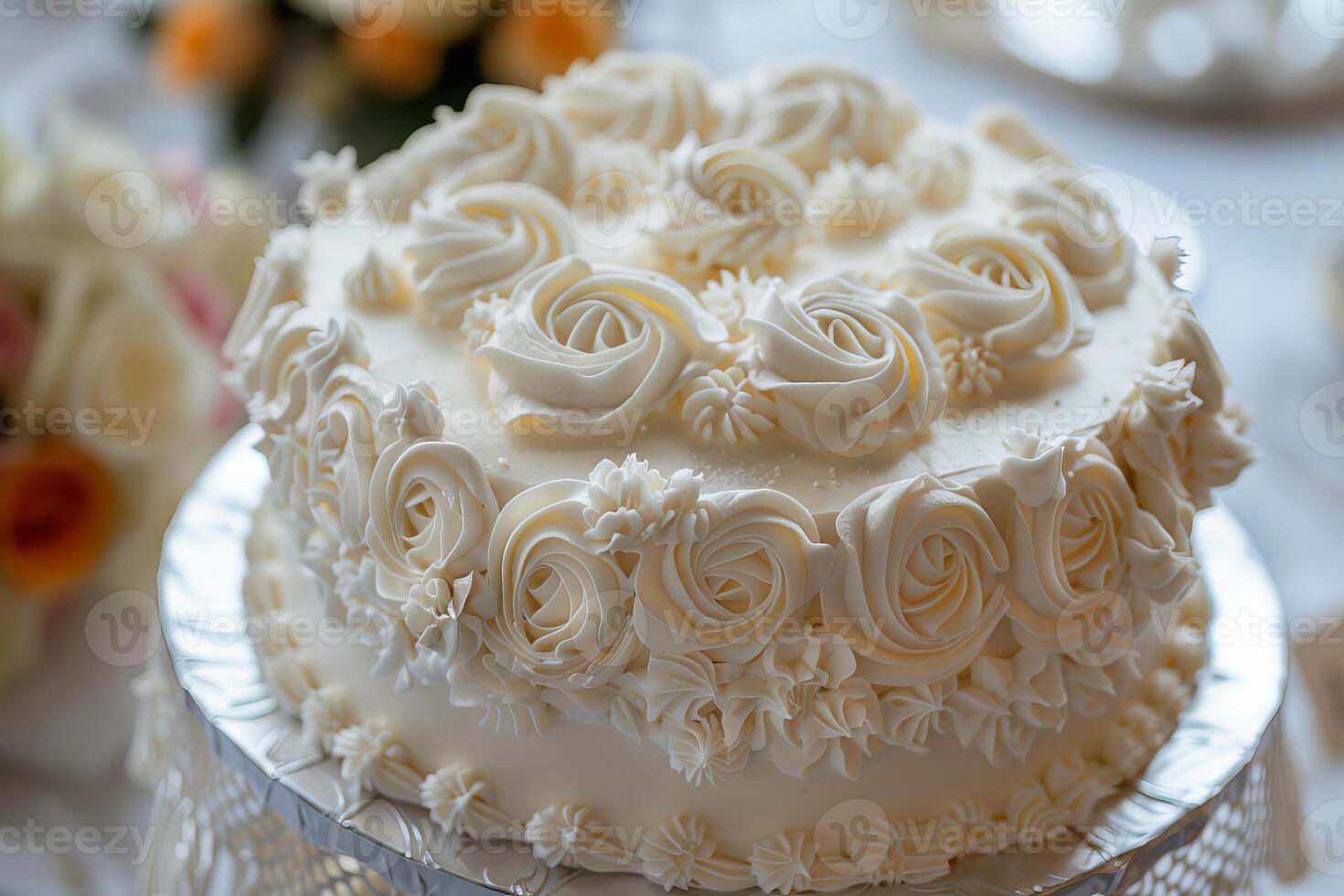 Delicious white cake decorated with icing roses being prepared for a wedding reception photo