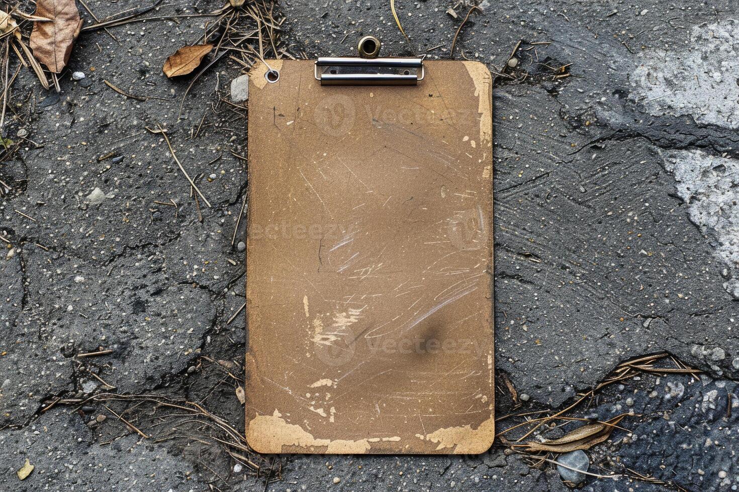 Old empty clipboard lying on the ground with copy space photo