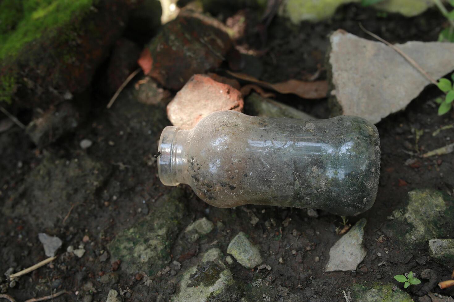 used bottles scattered in the yard photo