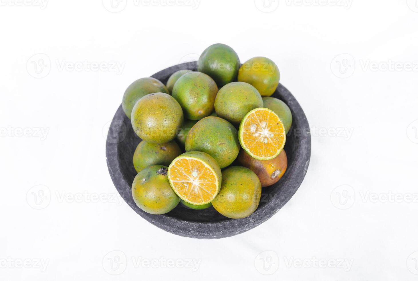 Green orange fruit or Tangerine orange with half slice and green leaves in Traditional Mortar isolated on white background. top view. photo