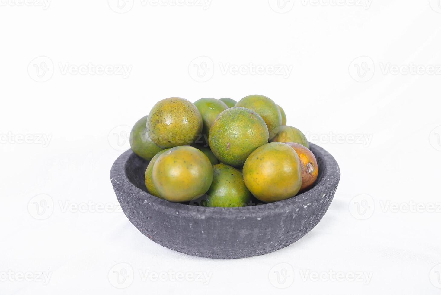 Green orange fruit or Tangerine orange with half slice and green leaves in Traditional Mortar isolated on white background. photo