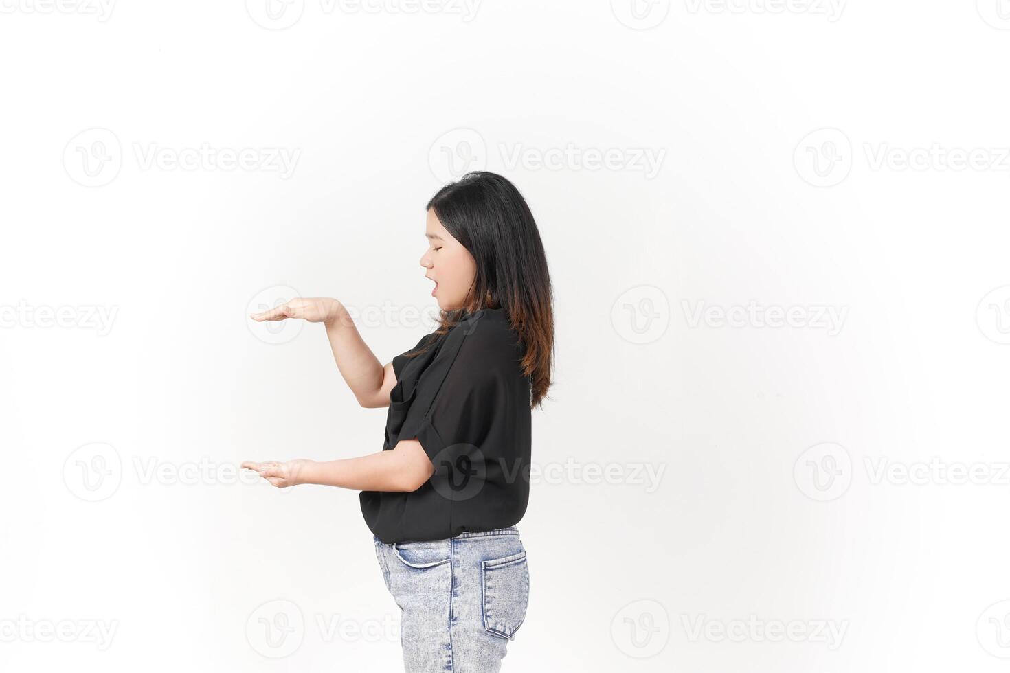 Young Asian woman Measuring and Showing Big Product wearing Black t-shirt and jeans isolated on white background photo