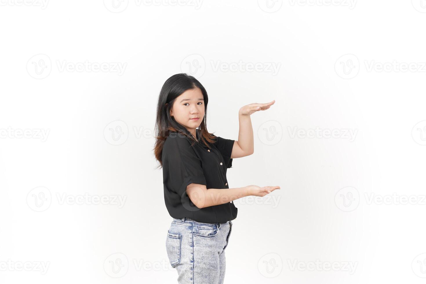 Young Asian woman Measuring and Showing Big Product wearing Black t-shirt and jeans isolated on white background photo